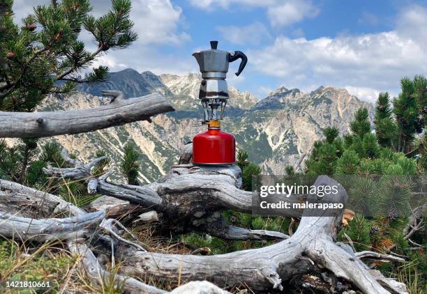 moka coffee on portable camping stove in the mountain - burner stove top stockfoto's en -beelden