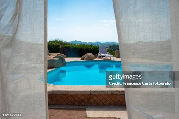 a view of luxury house with pool - sardinien stock-fotos und bilder