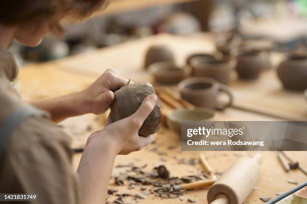 close up woman hands carving patterns ceramic clay on pottery - art passion stock pictures, royalty-free photos & images