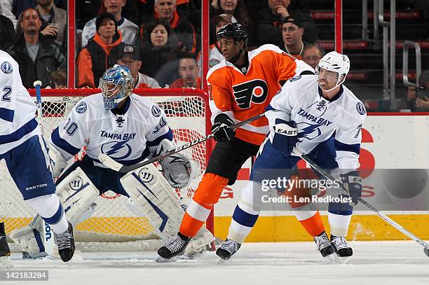 Wayne Simmonds of the Philadelphia Flyers positions himself in the crease against Dwayne Roloson and Brett Clark of the Tampa Bay Lightning on March...