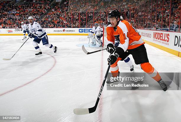 Sean Couturier of the Philadelphia Flyers skates against Brett Clark of the Tampa Bay Lightning on March 26, 2012 at the Wells Fargo Center in...