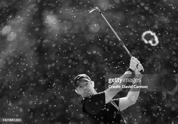 Black and white conversion of original colour file: Rory McIlroy of Northern Ireland plays his second shot on the sixth hole during a heavy rain...