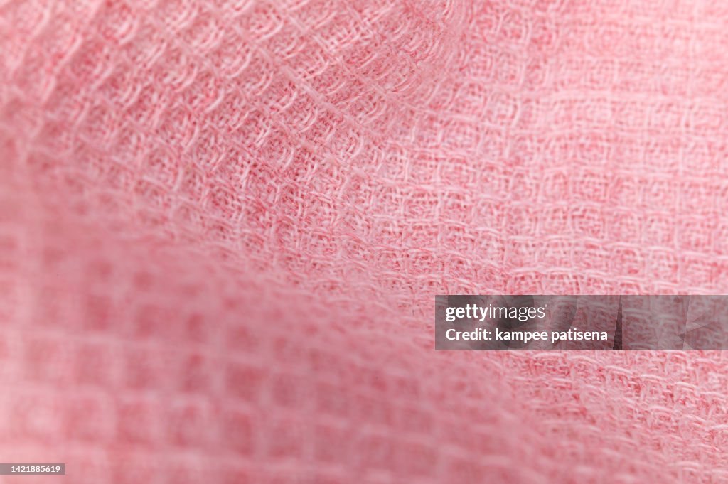 Texture of knitted pink fabric. pink background.