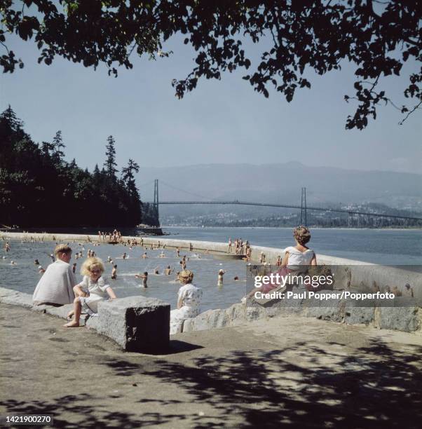 Children enjoy swimming in a lido at Stanley Park beside the Burrard Inlet in the city of Vancouver in British Columbia, Canada in September 1951. In...
