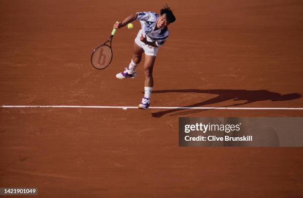 Michael Chang of the United States reaches to serve against compatriot Jim Grabb during their Men's Singles First Round match at the French Open...