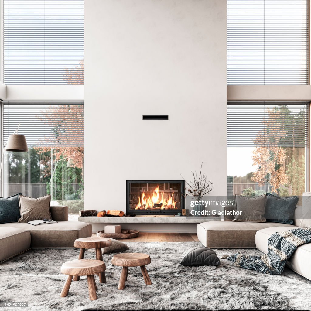 Gemütliches, luxuriöses und modernes Wohnzimmer mit großen Fenstern, Sofa, Dekoration und Kamin