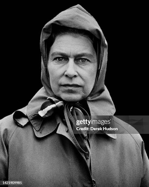 Queen Elizabeth II wearing a hooded raincoat at the Royal Windsor Horse Show, Berkshire 1975.