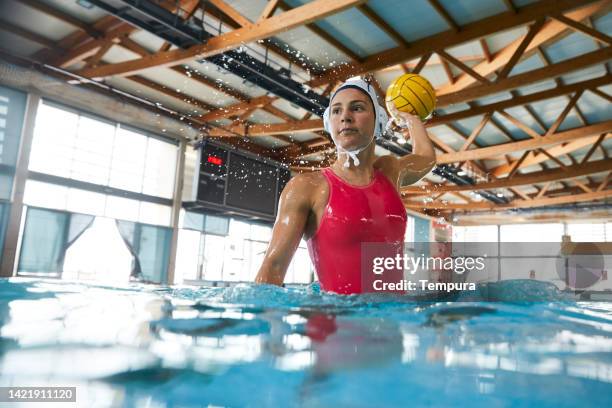 professional woman water polo player takes a shot. - waterpolo imagens e fotografias de stock