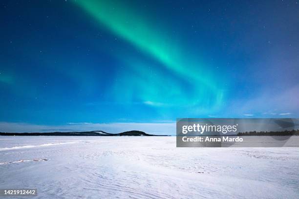 green northern lights on the sky at lake inari - inari finland bildbanksfoton och bilder