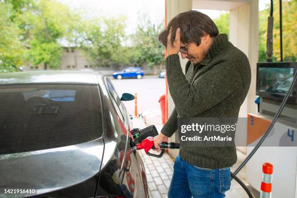 upset man at a gas s - change dispenser stock pictures, royalty-free photos & images