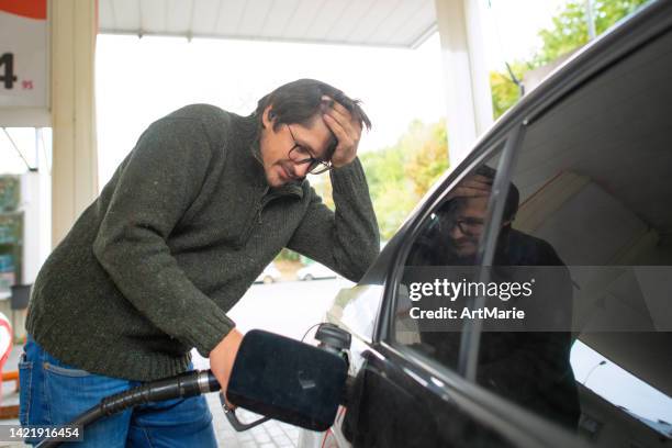 upset man at a gas s - refuelling stock pictures, royalty-free photos & images