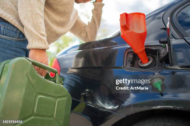 upset man with empty refuel canister near his car - canister stock pictures, royalty-free photos & images