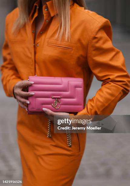 Sonia Lyson is seen wearing orange Remain leather mini dress and Jimmy Choo Varenne Avenue pink leather clutch bag, during Berlin Fashion Week...