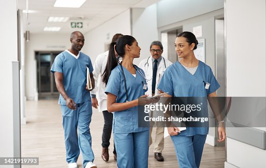 Doctor, nurse and walking hospital team after success surgery, medicine meeting or clinic insurance planning. Diversity workers, smile and happy medical healthcare teamwork on treatment collaboration Doctor, nurse and walking hospital team after success surgery, medicine meeting or clinic insurance planning. Diversity workers, smile and happy medical healthcare teamwork on treatment collaboration