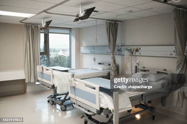 healthcare, insurance and medical hospital bed interior or ward room for insurance, health care or clinic background. covid 19, disease and specialized treatment center for ill, sick or recovery - hospital bed stock pictures, royalty-free photos & images