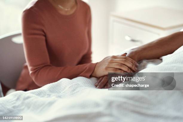 cancer, healthcare and support with a woman holding hands with her man in the hospital. medicine, insurance and trust with a couple in a clinic for treatment or help before death, mourning and loss - final imagens e fotografias de stock