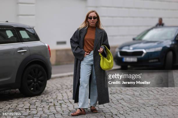 Sonia Lyson is seen wearing black Dior shades, brown turtleneck and grey long wool coat from Ivy & Oak, Ivy & Oak light blue denim jeans, Miu Miu...