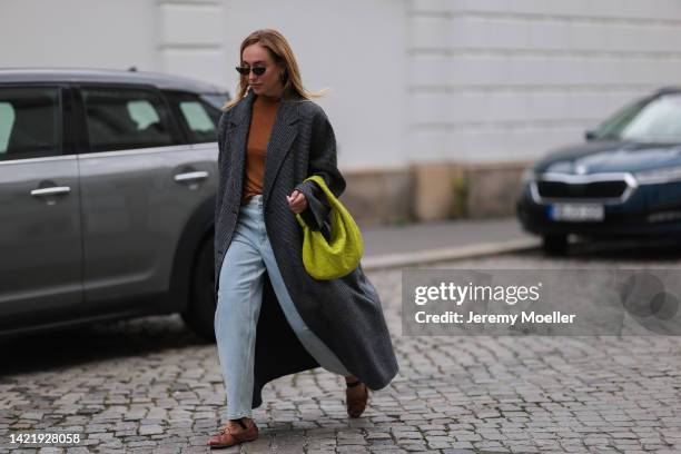 Sonia Lyson is seen wearing black Dior shades, brown turtleneck and grey long wool coat from Ivy & Oak, Ivy & Oak light blue denim jeans, Miu Miu...