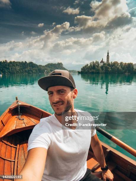 man take a selfie on a boat - lake bled stockfoto's en -beelden