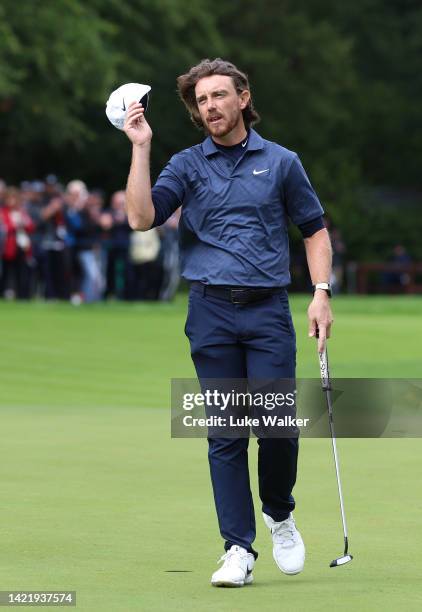 Tommy Fleetwood of England waves to the crowd on the 18th green during Day One of the BMW PGA Championship at Wentworth Golf Club on September 08,...