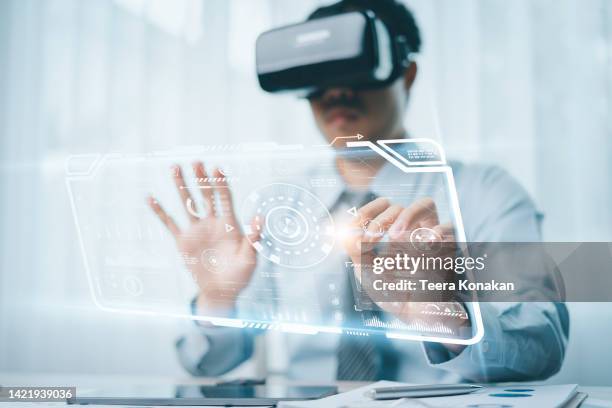 business man having a remote meeting over the internet using vr glasses at the office. metaverse concept. - erweiterte realität stock-fotos und bilder