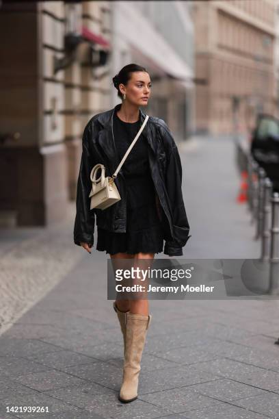 Celine Bethmann is seen wearing gold earrings, black t-shirt, black lace shorts, black leather vintage leather jacket, beige leather Jacquemus...