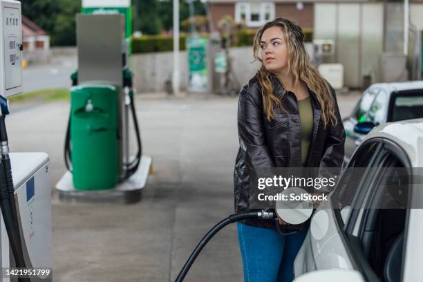 keeping to budget at the petrol station - auto garage stock pictures, royalty-free photos & images