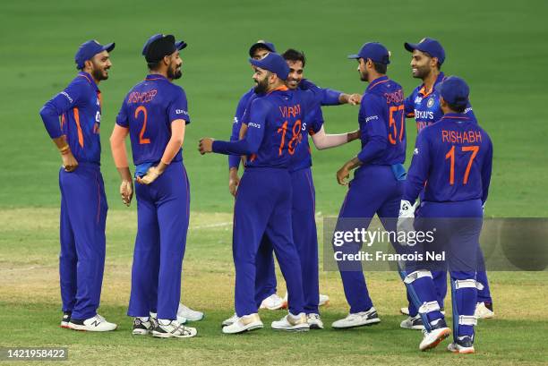 Bhuvneshwar Kumar of India celebrates with team mates after dismissing Azmatullah Omarzai of Afghanistan during the DP World Asia Cup match between...