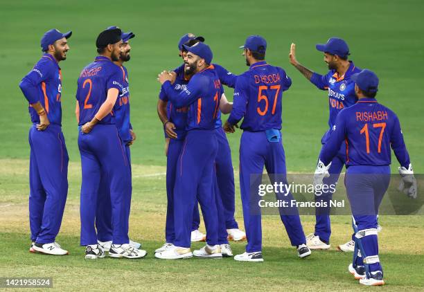 Bhuvneshwar Kumar of India celebrates with team mates after dismissing Azmatullah Omarzai of Afghanistan during the DP World Asia Cup match between...