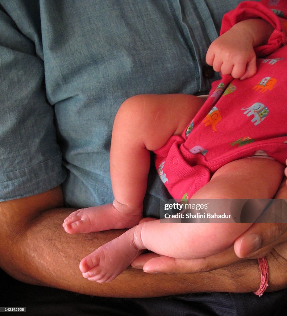 Newborn daughter in her father arms