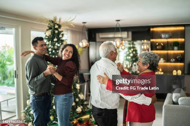 family dancing on christmas time at home - mexican christmas stock pictures, royalty-free photos & images