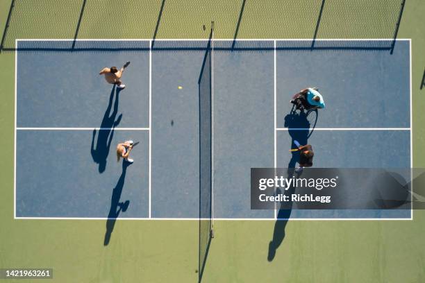 young adults playing pickleball on a public court - tennis championship stock pictures, royalty-free photos & images