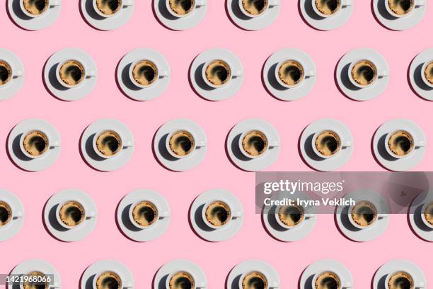 pattern made of cup of fresh coffee on pastel pink color background. - coffee stock pictures, royalty-free photos & images