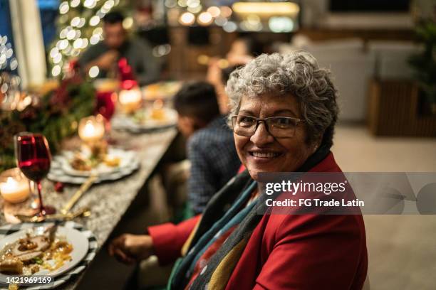 portrait of senior woman in the dinner table on christmas at home - mexico christmas stock pictures, royalty-free photos & images