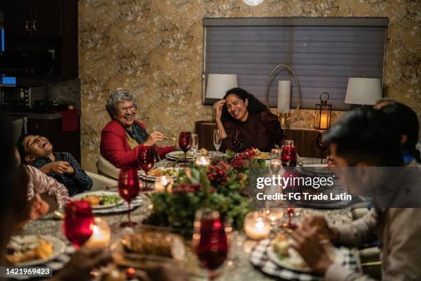 family talking in the dining table on christmas at home - mexico christmas stock pictures, royalty-free photos & images