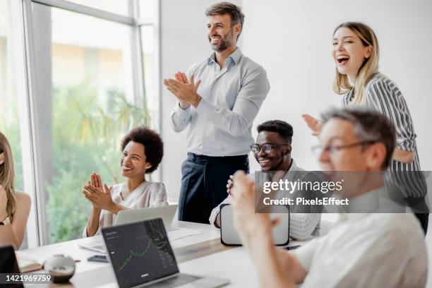 businesspeople clapping at conference in a corporate office - office happy congratulations stock pictures, royalty-free photos & images