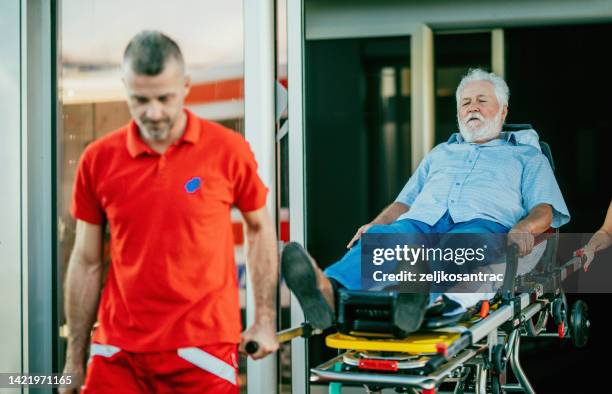 Help Injured Paramedics Providing First Aid To Older Man Injured In Accident High ...