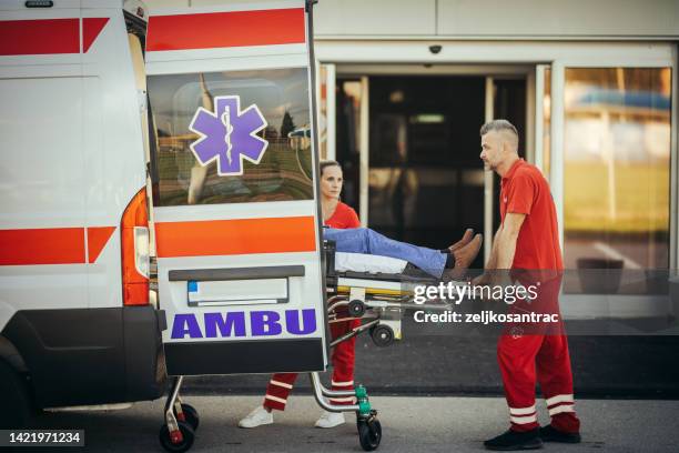 paramedics providing first aid to older man  injured  in accident - bår på hjul bildbanksfoton och bilder