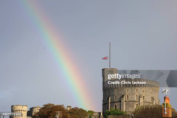 The Union flag is lowered on Windsor Castle as a rainbow covers the sky on September 08, 2022 in Windsor, England. Elizabeth Alexandra Mary Windsor...