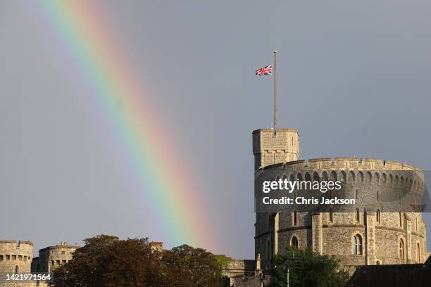 The Union flag is lowered on Windsor Castle as a rainbow covers the sky on September 08, 2022 in Windsor, England. Elizabeth Alexandra Mary Windsor...