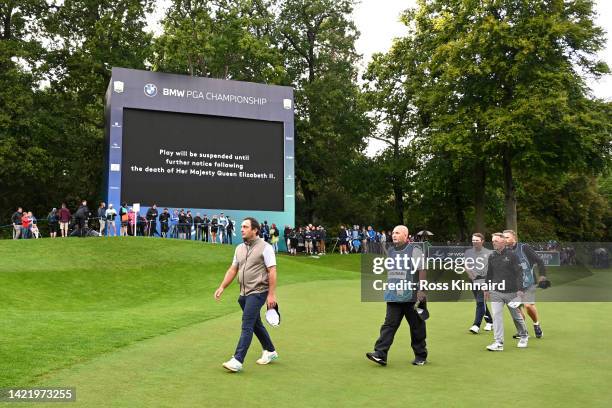 Luke Donald of England leaves the 18th green following the announcement of the death of Her Majesty Queen Elizabeth II during Day One of the BMW PGA...