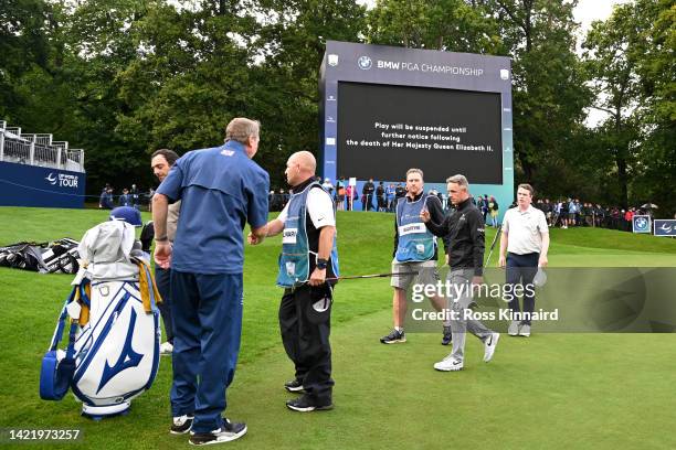 Luke Donald of England leaves the 18th green following the announcement of the death of Her Majesty Queen Elizabeth II during Day One of the BMW PGA...
