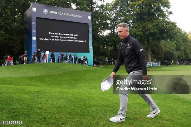 Luke Donald of England leaves the 18th green following the announcement of the death of Her Majesty Queen Elizabeth II during Day One of the BMW PGA...
