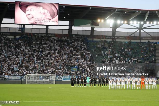 Players and fans participate in a minute’s silence after it was announced that Queen Elizabeth II has passed away today during the UEFA Europa League...