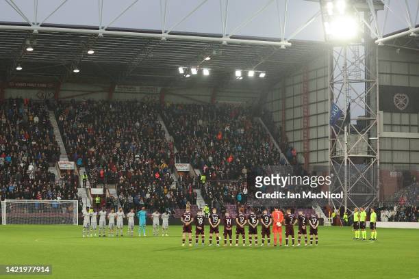 Players of Heart of Midlothian and Istanbul Basaksehir hold a minutes silence before the second half after it was announced that Queen Elizabeth II...