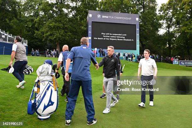 Luke Donald of England leaves the 18th green as play is suspended following the announcement of the death of Her Majesty Queen Elizabeth II during...