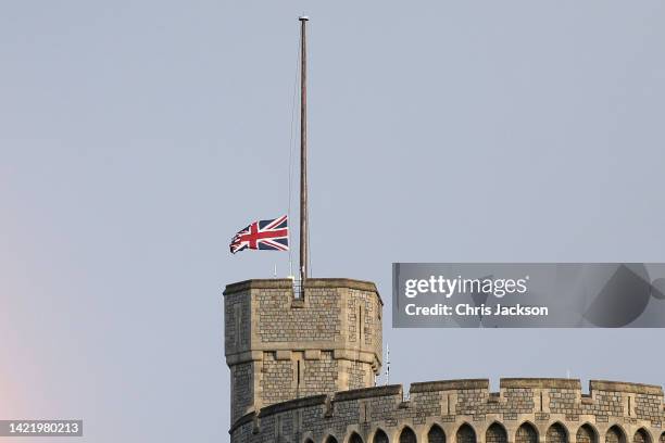 The Union flag is lowered on Windsor Castle as a rainbow covers the sky on September 08, 2022 in Windsor, England. Elizabeth Alexandra Mary Windsor...