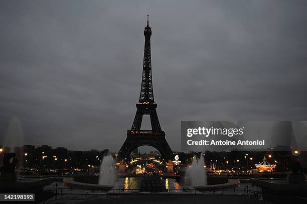 The Eiffel Tower is seen after the lights are turned off during Earth Hour 2012, on March 31, 2012 in Paris, France. CAcording to organisers the...