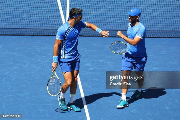 Juan Sebastian Cabal and Robert Farah of Colombia celebrate a point against Rajeev Ram of the United States and Joe Salisbury of Great Britain during...