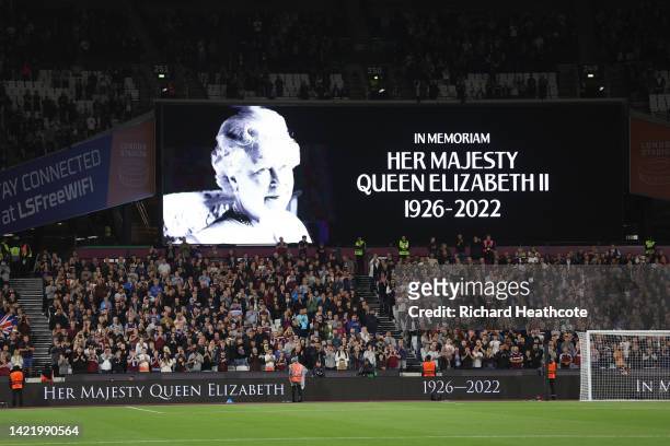 The LED board shows a photo Queen Elizabeth II as players of West Ham United and FCSB observe a minutes silence after it was announced that Queen...